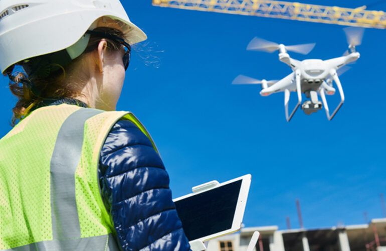 Security personnel monitoring a construction site with a drone