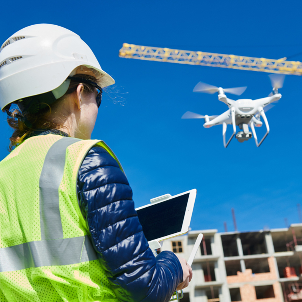Security personnel monitoring a construction site with a drone