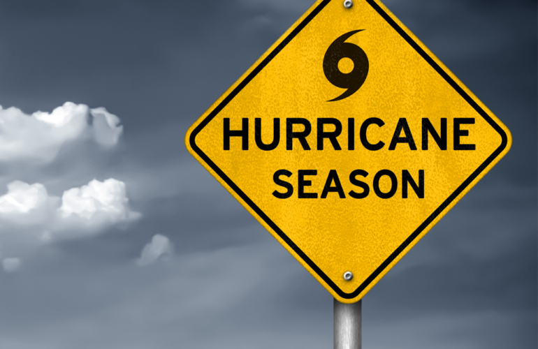 Hurricane season warning sign against a stormy sky